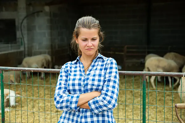 Image of woman with crossed arms with a contemplative look